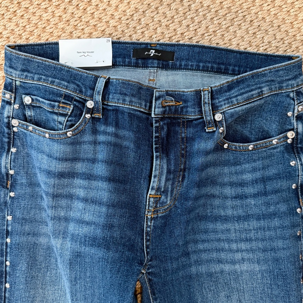 Stylish Blue Jeans with silver stud Accents on sides of legs and pockets.